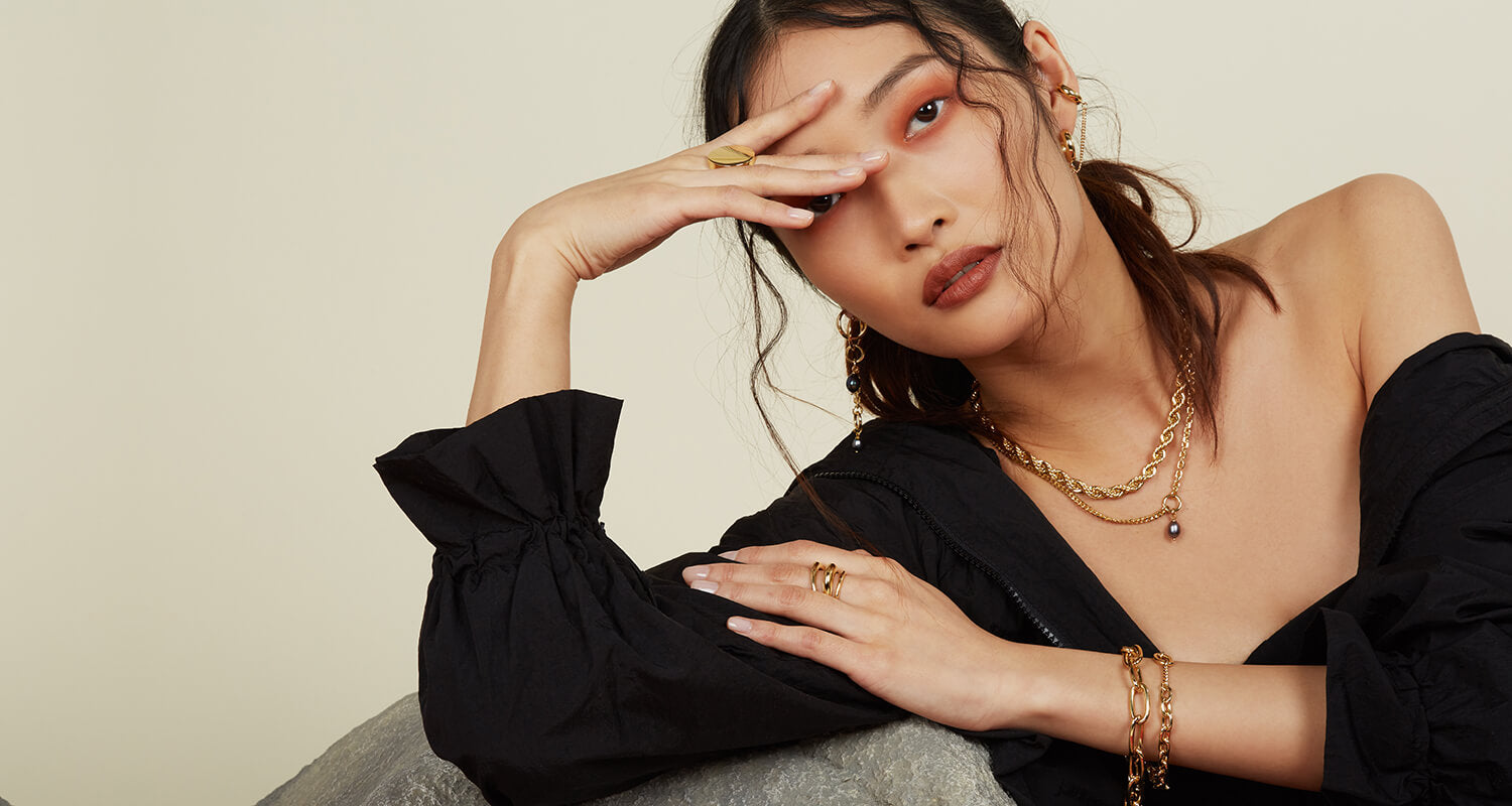 Lady Grey Jewelry FW21 Collection campaign image with ear cuffs, rope chain necklace, layered rings, necklaces, and bracelets.