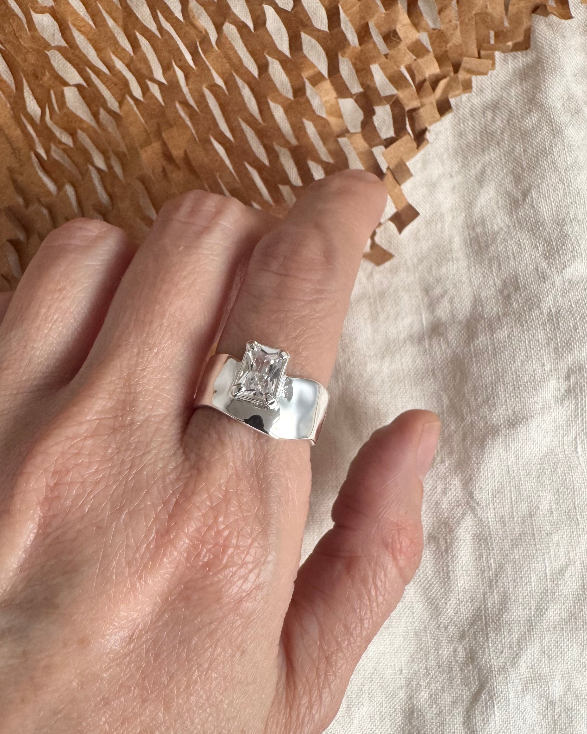 Lady Grey Wade Ring in Silver with a CZ on a textured surface