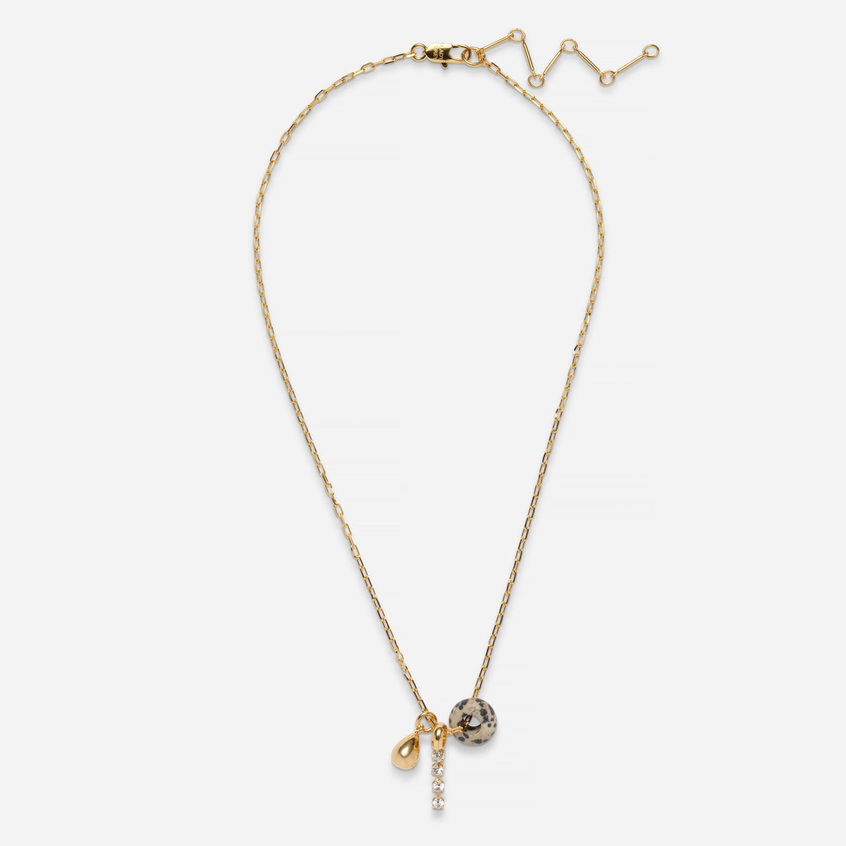 A delicate gold chain necklace with a small teardrop charm, a faceted crystal ball charm, and a short vertical crystal drop, displayed on a clean white background.